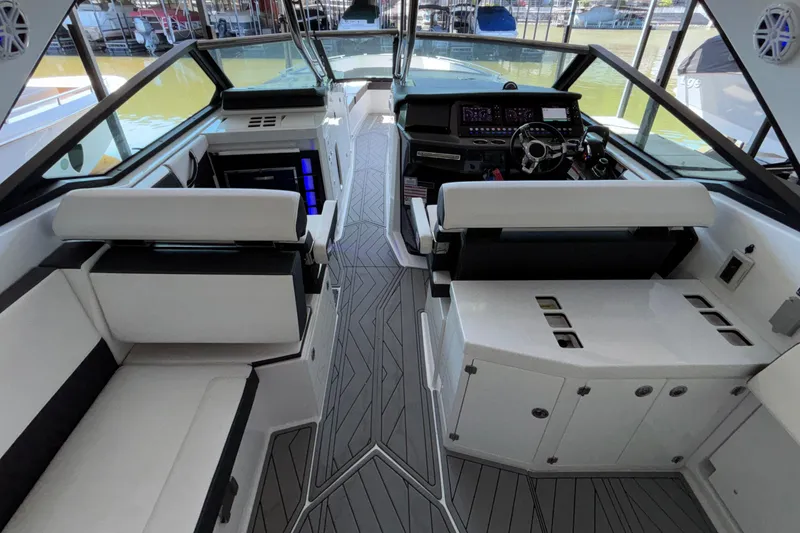 Slide: The Image of 2023 Monterey 385SS Super Sport boat interior with modern seating and sleek dashboard design. - 18