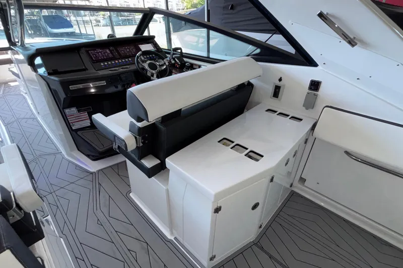 Slide: The Image of 2023 Monterey 385SS Super Sport boat interior with modern helm and seating area. - 21