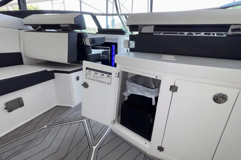 Slide: The Image of 2023 Monterey 385SS Super Sport interior with open storage compartment and seating area. - 22