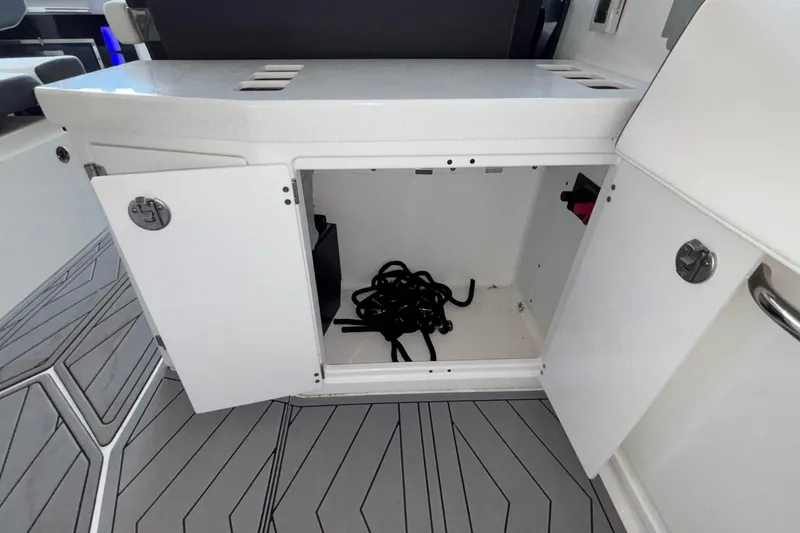 Slide: The Image of Open storage compartment on 2023 Monterey 385SS Super Sport boat, featuring sleek interior design. - 23