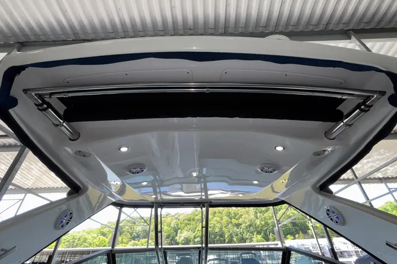 Slide: The Image of 2023 Monterey 385SS Super Sport boat interior with speakers and lighting under canopy. - 31