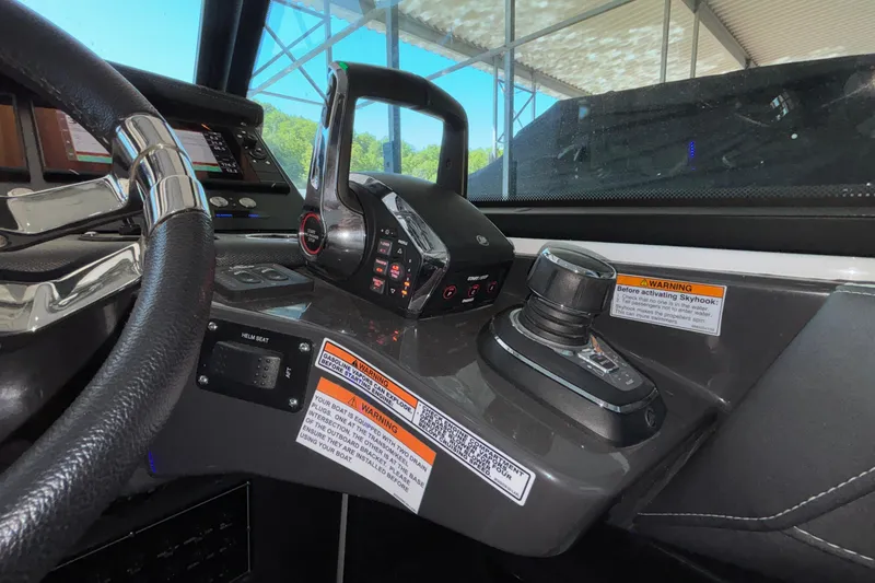 Slide: The Image of 2023 Monterey 385SS Super Sport helm with controls and warning labels. - 43