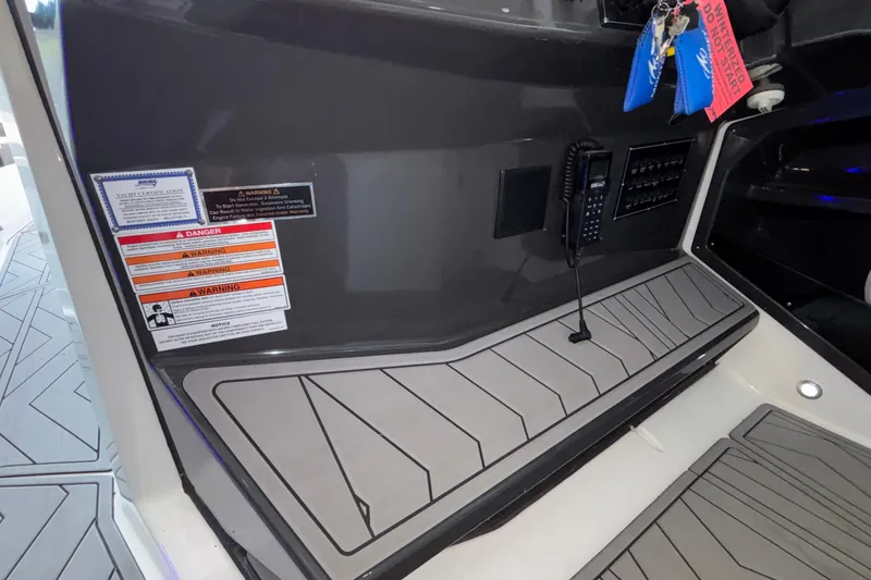 Slide: The Image of Interior view of a 2023 Monterey 385SS Super Sport boat with control panel and warning labels. - 46