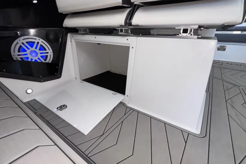 Slide: The Image of 2023 Monterey 385SS Super Sport boat interior storage compartment with blue LED speaker. - 52
