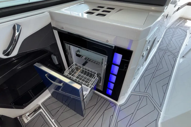 Slide: The Image of 2023 Monterey 385SS Super Sport boat interior with open mini fridge and modern design. - 53