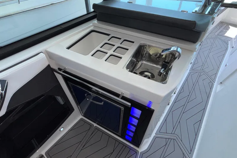 Slide: The Image of 2023 Monterey 385SS Super Sport boat interior with sink and storage area. - 54