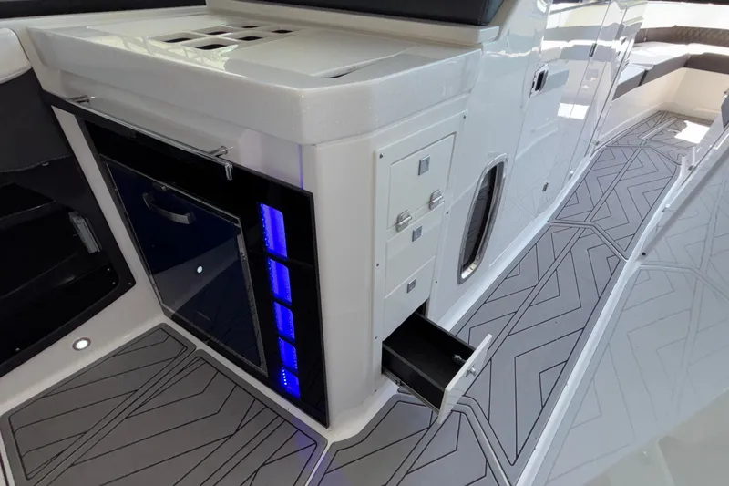 Slide: The Image of 2023 Monterey 385SS Super Sport boat interior with sleek cabinetry and modern flooring design. - 59