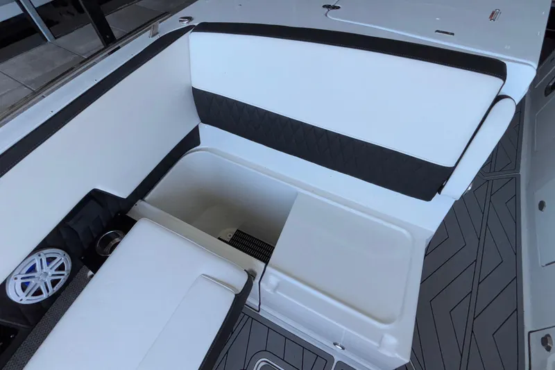 Slide: The Image of 2023 Monterey 385SS Super Sport boat interior with white and black seating and storage compartment. - 71