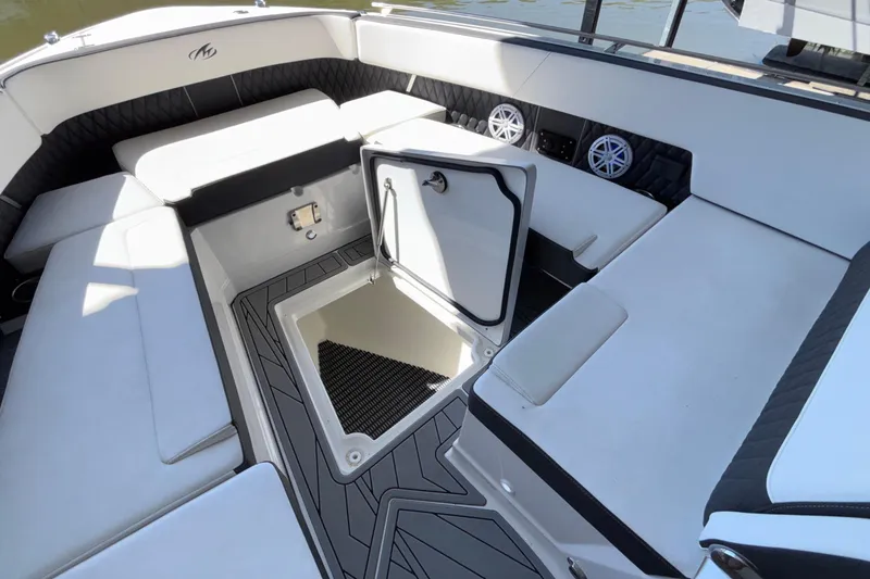 Slide: The Image of 2023 Monterey 385SS Super Sport boat interior with open storage compartment and seating. - 73