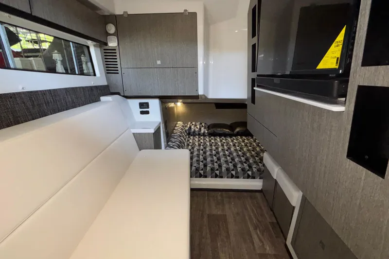 Slide: The Image of Interior of 2023 Monterey 385SS Super Sport boat with modern seating and sleeping area. - 79