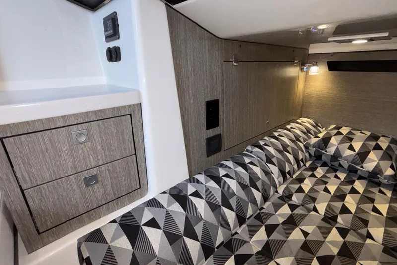 Slide: The Image of 2023 Monterey 385SS Super Sport cabin interior with geometric-patterned bedding and modern cabinetry. - 82