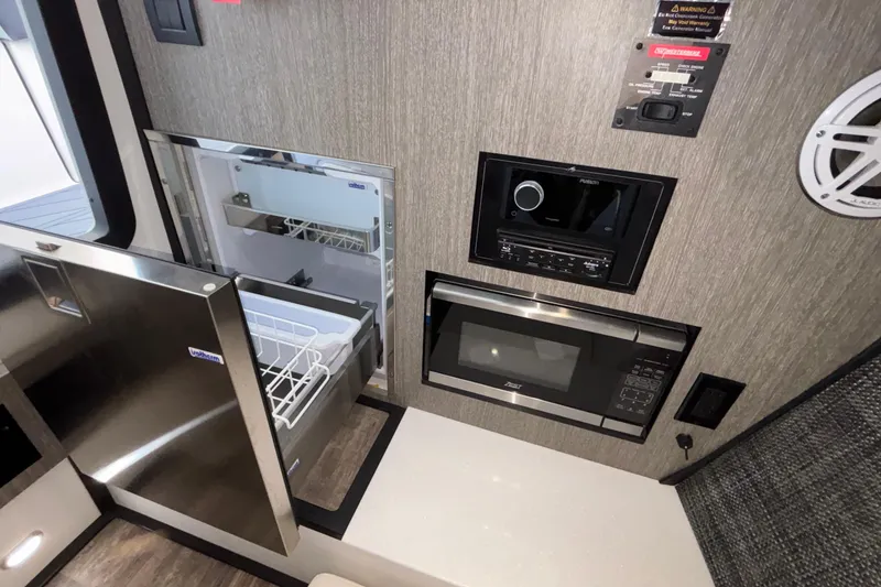 Slide: The Image of 2023 Monterey 385SS Super Sport interior with microwave, stereo, and refrigerator. - 84