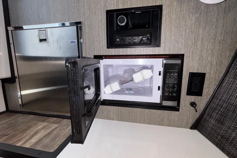 Slide: The Image of 2023 Monterey 385SS Super Sport interior with microwave, fridge, and audio system. - 85