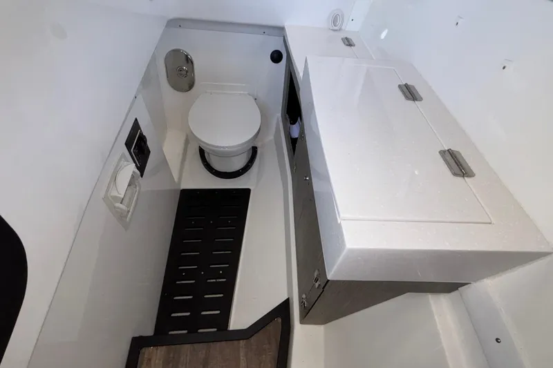 Slide: The Image of 2023 Monterey 385SS Super Sport boat bathroom with toilet and storage cabinet. - 89