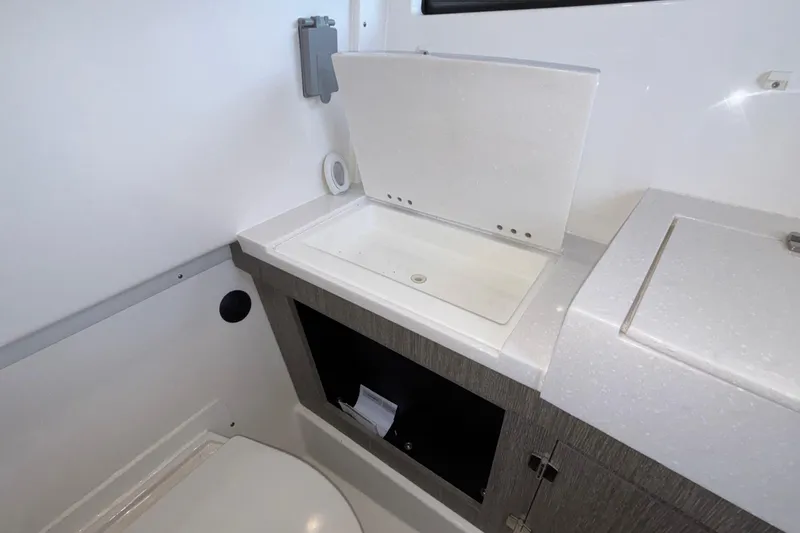 Slide: The Image of 2023 Monterey 385SS Super Sport boat bathroom with modern sink and storage. - 91