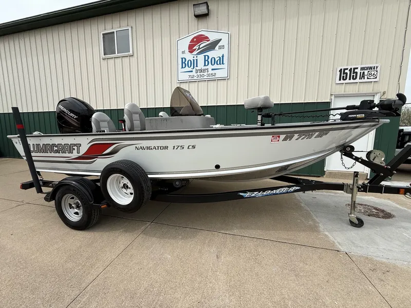 Slide: The Image of 2010 Alumacraft Navigator 175 CS boat on trailer in front of building. - 1