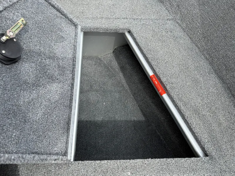 Slide: The Image of Alumacraft Navigator 175 CS 2010 boat compartment with carpeted interior. - 17