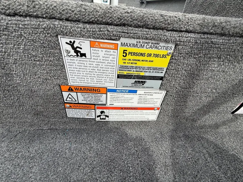 Slide: The Image of Safety and capacity warnings on Alumacraft Navigator 175 CS boat. - 23
