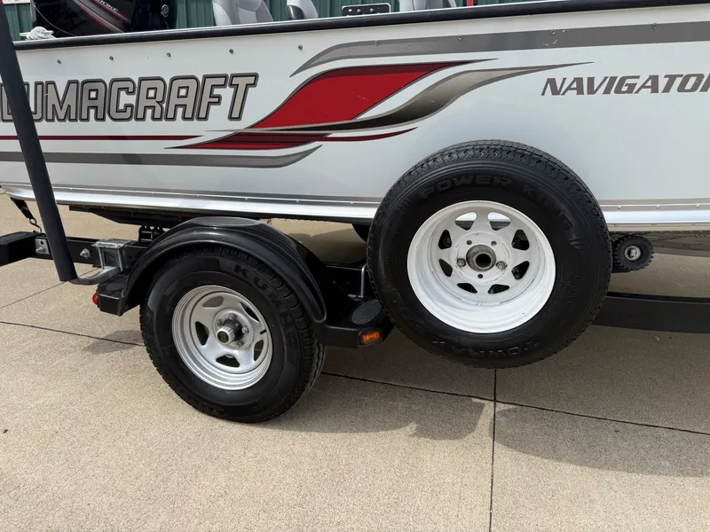 Slide: The Image of 2010 Alumacraft Navigator 175 CS boat trailer with white tires. - 31