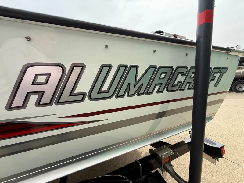 Slide: The Image of 2010 Alumacraft Navigator 175 CS boat side view with logo. - 4