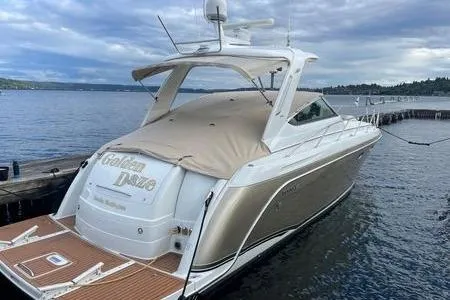 Slide: The Image of 2008 Formula 40 Performance Cruiser docked on a serene lake under cloudy skies. - 2