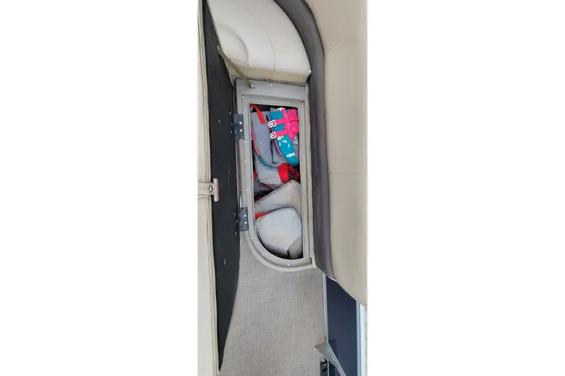 Slide: The Image of Storage compartment on 2020 SUNTRACKER BASS BUGGY 16 XLS boat, containing life jackets. - 11