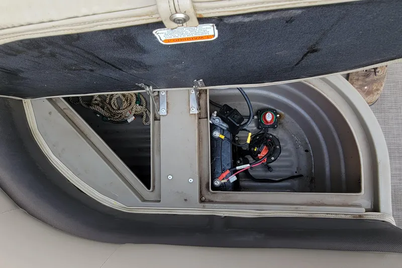 Slide: The Image of 2020 SUNTRACKER BASS BUGGY 16 XLS battery compartment with wiring and storage space. - 12