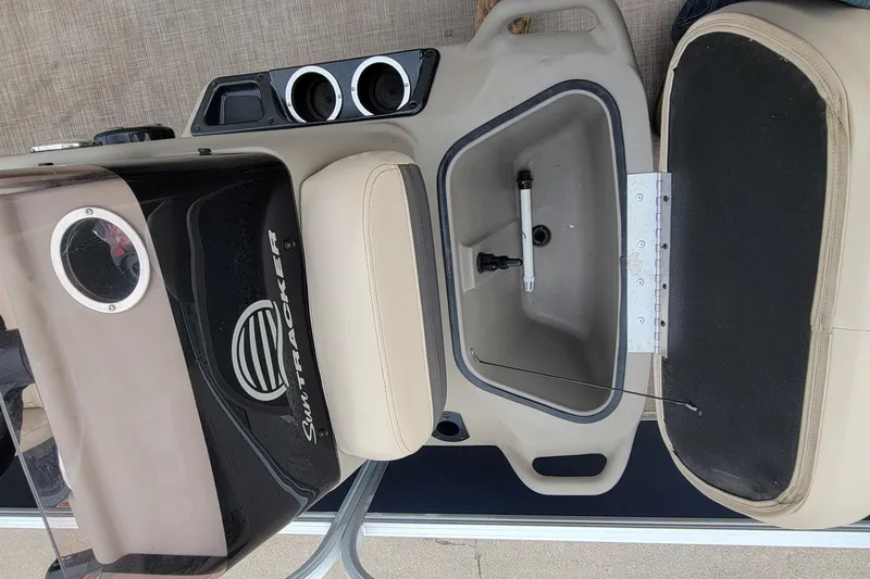 Slide: The Image of 2020 SUNTRACKER BASS BUGGY 16 XLS boat interior with storage compartment and cup holders. - 15