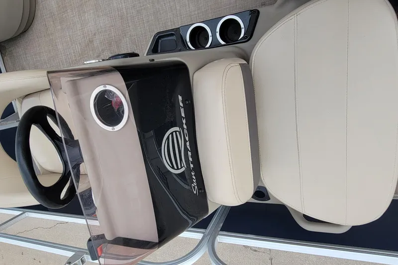 Slide: The Image of 2020 SUNTRACKER BASS BUGGY 16 XLS boat console with steering wheel and cup holders. - 16