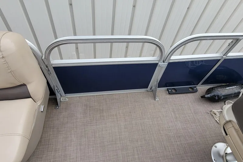 Slide: The Image of Interior of 2020 SUNTRACKER BASS BUGGY 16 XLS pontoon boat with beige seating and blue paneling. - 18