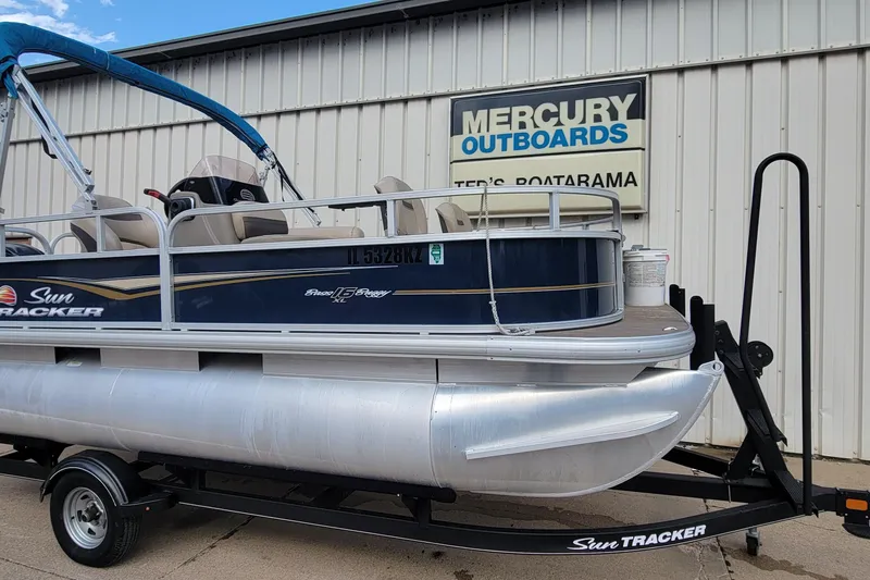 Slide: The Image of 2020 SUNTRACKER BASS BUGGY 16 XLS pontoon boat on trailer at dealership. - 2