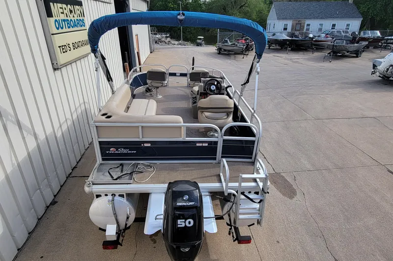 Slide: The Image of 2020 SUNTRACKER BASS BUGGY 16 XLS pontoon boat with Mercury 50 engine, parked at dealership. - 3
