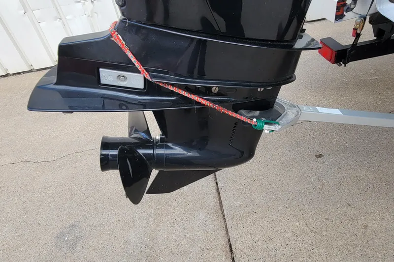 Slide: The Image of 2020 SUNTRACKER BASS BUGGY 16 XLS motor with safety rope on concrete surface. - 5