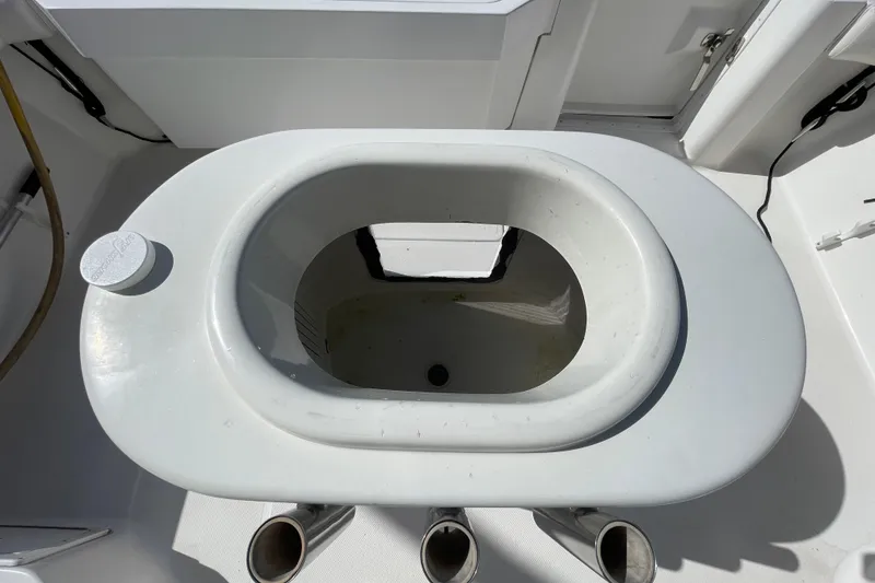 Slide: The Image of Livewell on 2003 Luhrs 34 Convertible boat, featuring a white oval design. - 11