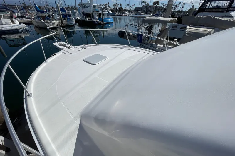 Slide: The Image of 2003 Luhrs 34 Convertible yacht deck in marina, surrounded by boats. - 14