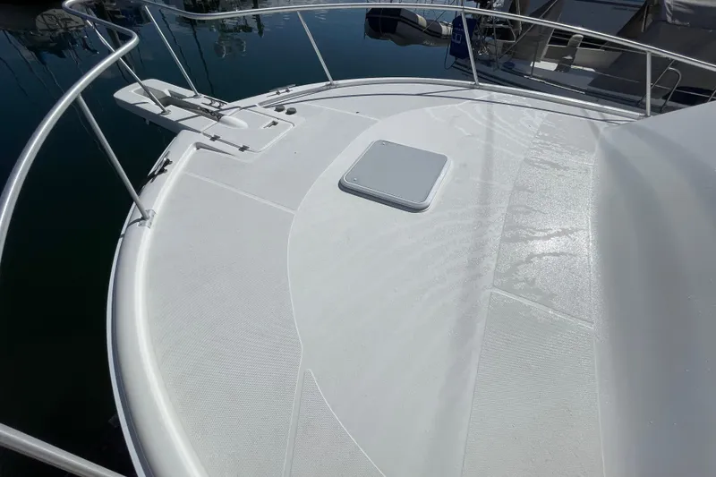 Slide: The Image of 2003 Luhrs 34 Convertible yacht deck with railing and hatch, docked in marina. - 15