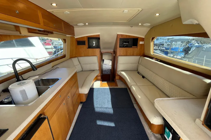 Slide: The Image of Interior of 2003 Luhrs 34 Convertible yacht with kitchen and seating area. - 19