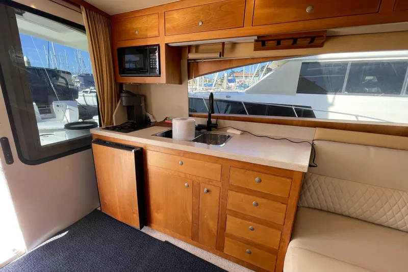 Slide: The Image of 2003 Luhrs 34 Convertible yacht interior with kitchenette and seating area. - 20