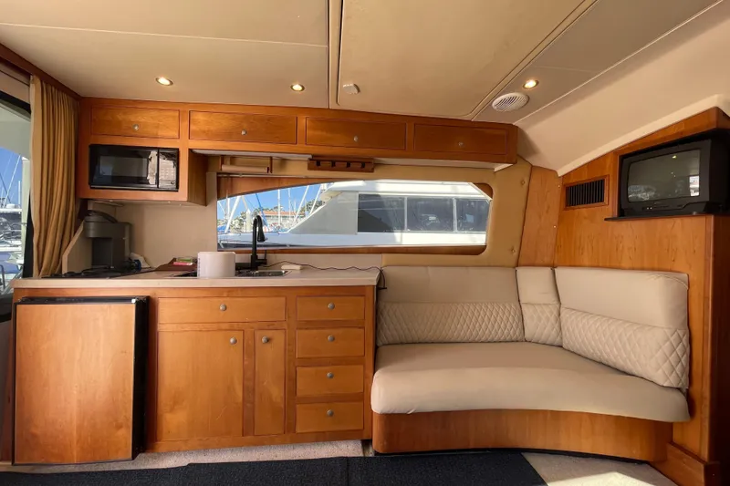 Slide: The Image of Interior of 2003 Luhrs 34 Convertible yacht with kitchenette and seating area. - 21