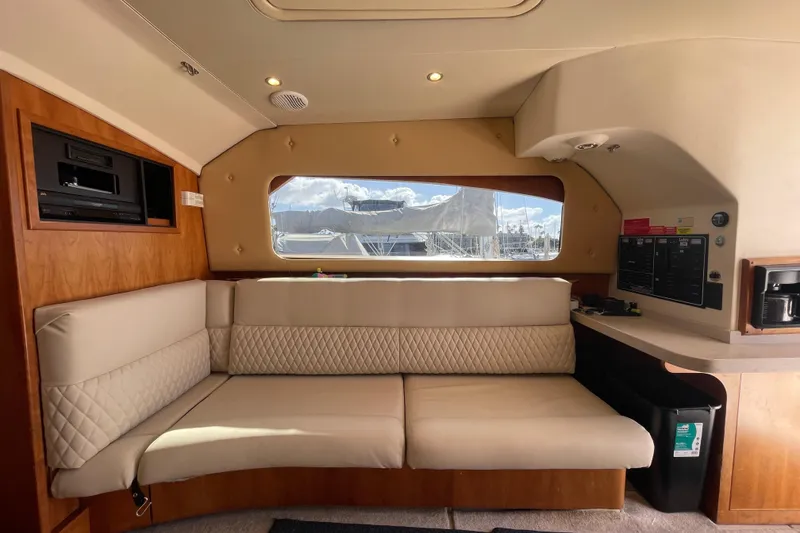 Slide: The Image of Interior of 2003 Luhrs 34 Convertible yacht with beige seating and wood accents. - 23