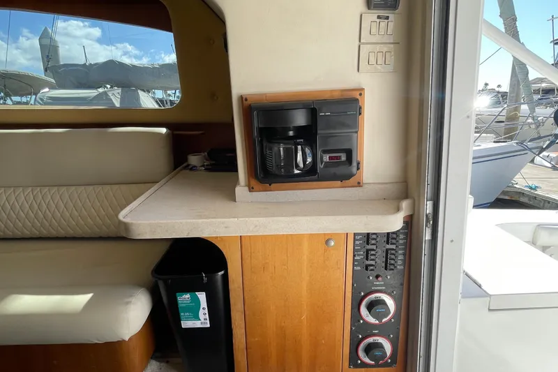 Slide: The Image of Interior of 2003 Luhrs 34 Convertible boat with coffee maker and control panel. - 24
