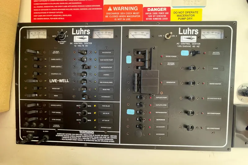 Slide: The Image of Luhrs 34 Convertible 2003 control panel with switches and warning labels. - 25