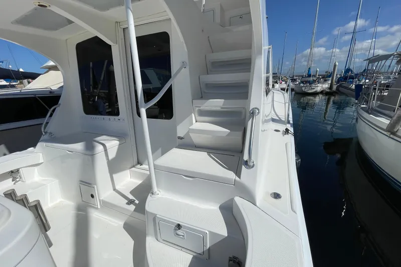 Slide: The Image of 2003 Luhrs 34 Convertible yacht deck with stairs and marina view. - 32