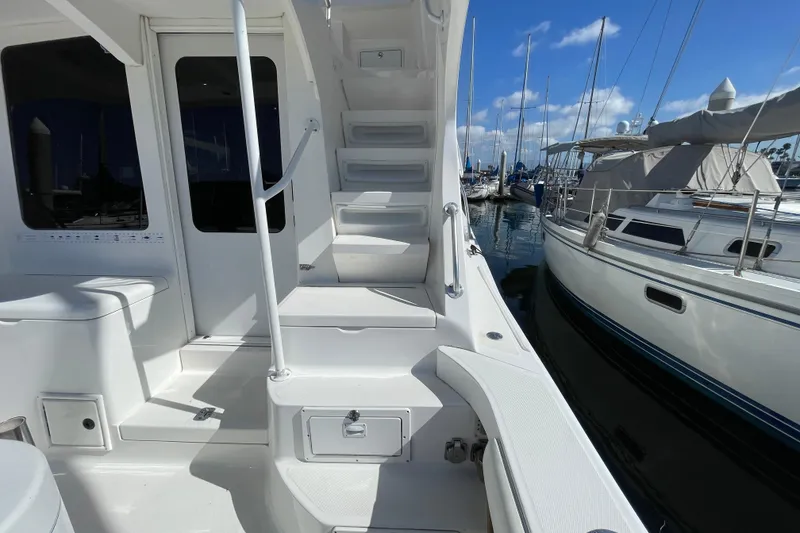 Slide: The Image of 2003 Luhrs 34 Convertible yacht deck with stairs and marina view. - 33