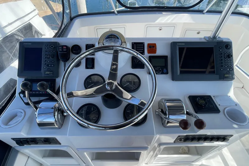 Slide: The Image of Helm of 2003 Luhrs 34 Convertible boat with steering wheel and navigation instruments. - 38