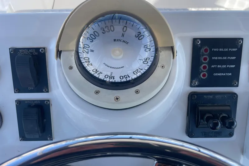 Slide: The Image of Compass and control panel on a 2003 Luhrs 34 Convertible boat. - 41