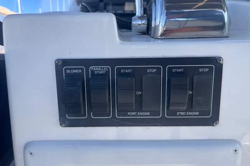 Slide: The Image of Control panel of a 2003 Luhrs 34 Convertible boat with engine switches. - 42