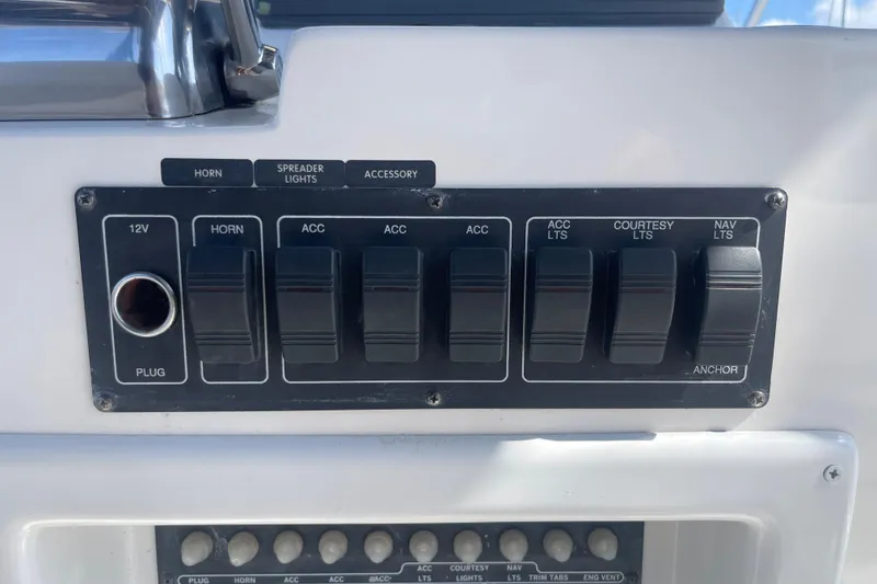 Slide: The Image of Control panel of a 2003 Luhrs 34 Convertible boat with labeled switches. - 43