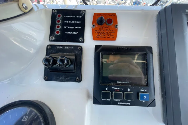 Slide: The Image of Control panel of a 2003 Luhrs 34 Convertible boat with bilge pump indicators. - 44