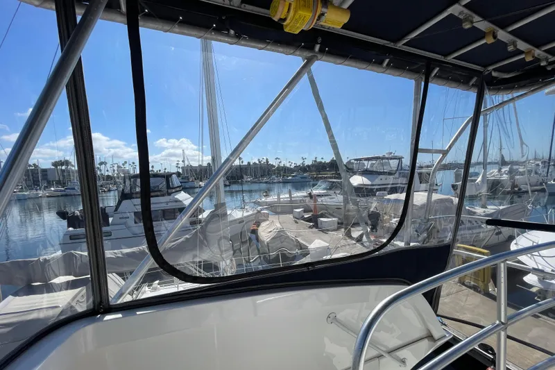 Slide: The Image of View from 2003 Luhrs 34 Convertible boat, overlooking marina with clear skies and docked yachts. - 47